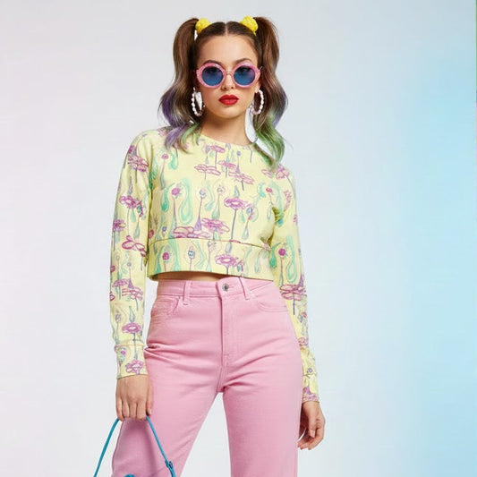 Pastel yellow long sleeve crop top with pink surrealist flower and eye print